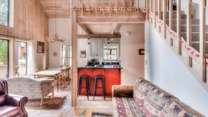 A rustic interior with a wooden staircase, a dining area, and a kitchen. - Relax at Rustic Tahoe Charm Minutes to Lake (Tahoma)