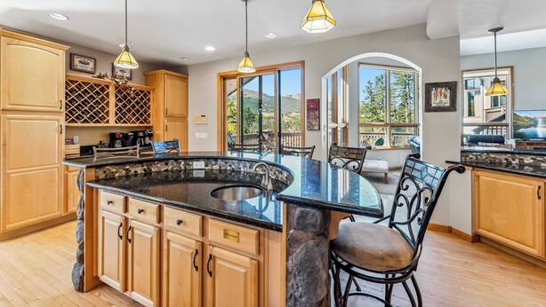 A kitchen with a large island, wooden cabinets, and pendant lighting. - Massive Breckenridge Estate: Game Room & Hot Tub! (Breckenridge)