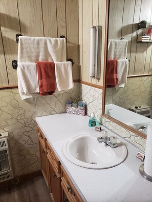 Combined shower/bathtub, towels, soap, toilet paper