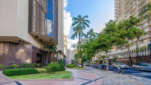 A modern building with a prominent sign for the Waikiki Trade Center.
