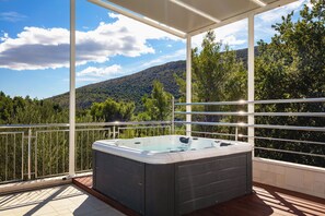 A hot tub on a balcony with a mountain view. - Luxury Villa Lovric Private Heated Pool (Omis)