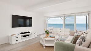 Relax in this coastal retreat with a flat-screen TV, console table, and comfortable sofa.