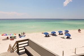 Guests can relax on the beach with access to the ocean and comfortable lounge chairs.