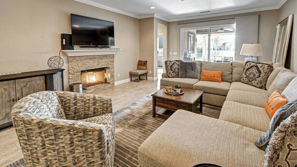 A living room with a fireplace, sofa, and television. - The Great Escape - Indio - Across from Coachella (Indio)