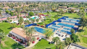 A large hotel complex with multiple tennis courts, a swimming pool, and a covered parking area. - The Great Escape - Indio - Across from Coachella (Indio)