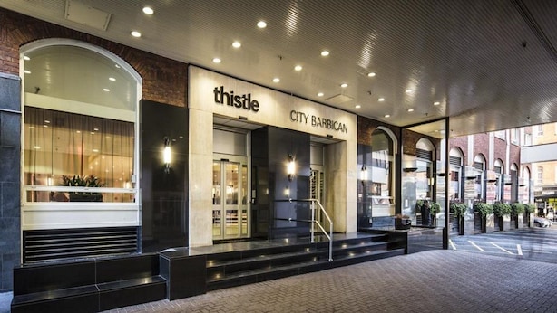 A modern building with a glass facade, a sign reading "thistle CITY BARBECAN," and a staircase leading to the entrance. - Thistle City Barbican (London)