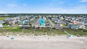 A coastal residential area with houses, a beach, and a water body. - "After Dune Delight" oceanfront, 7 bedroom 3 bathrooms (Holden Beach)