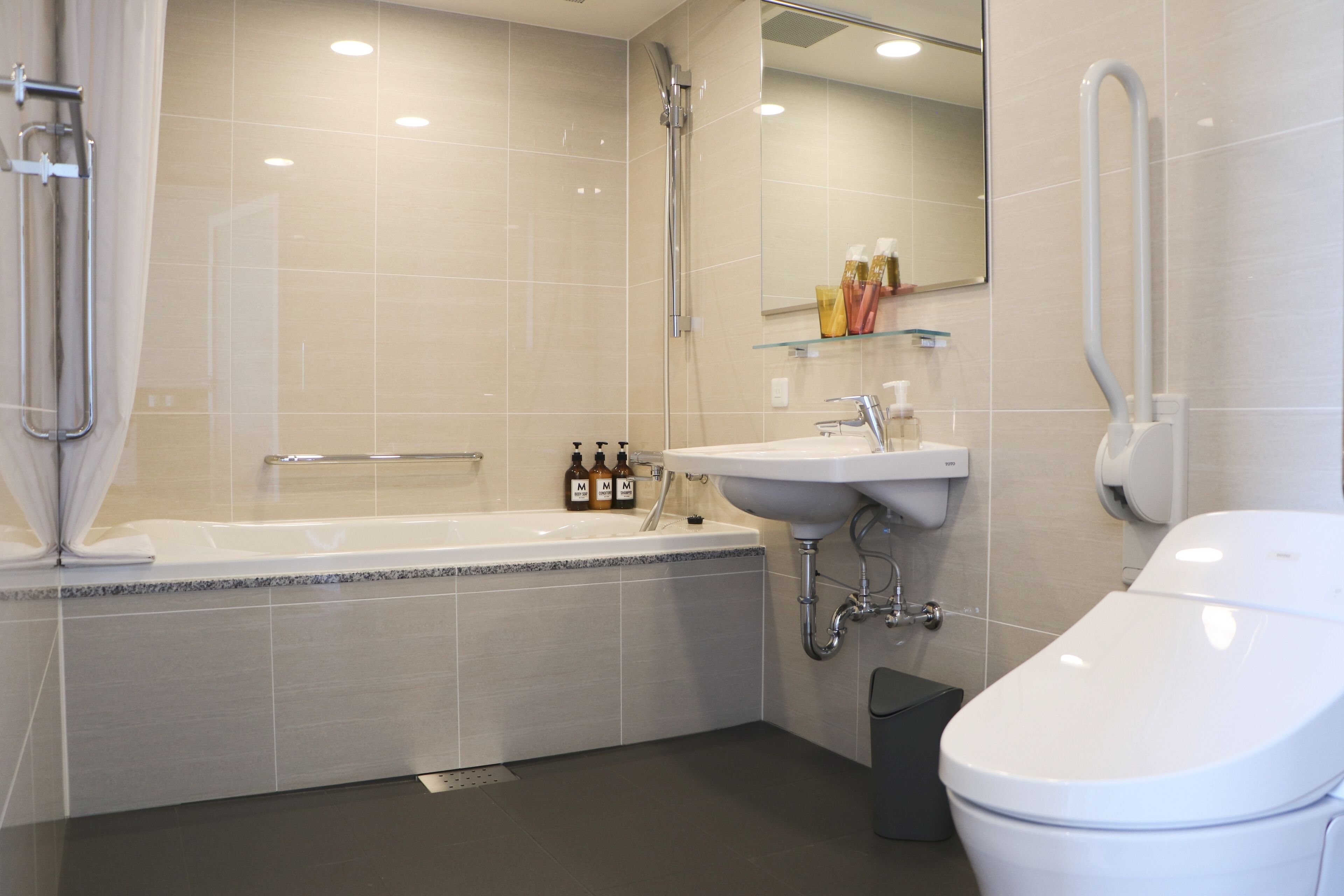 deluxe twin room | bathroom | rainfall showerhead, hair dryer, slippers, bidet