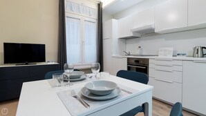 A modern kitchen with white cabinets, a built-in oven, and a coffee maker on the counter. - Italianway - Garibaldi 104 C (Milan)