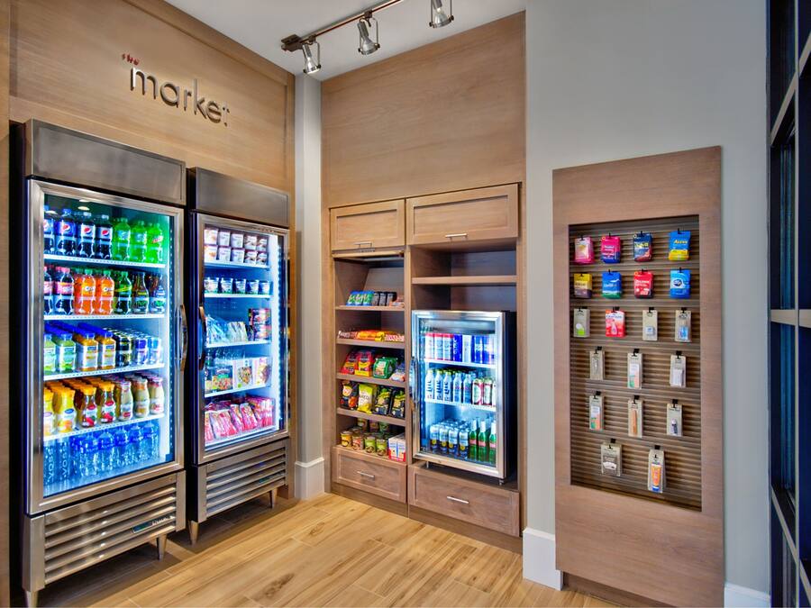 A store interior with refrigerated beverage displays, snack shelves, and a section for packaged goods.