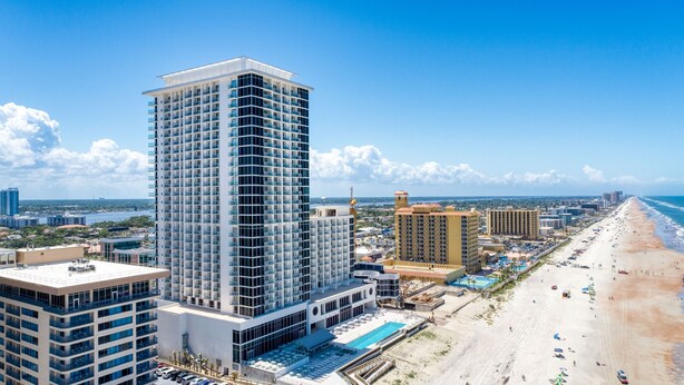 A high-rise hotel with multiple floors, a rooftop pool, and a beachside location. - Daytona Grande Oceanfront Resort (Daytona Beach)