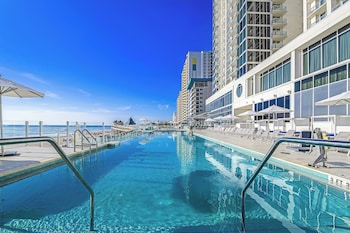 Outdoor pool, open 7:00 AM to 8:00 PM, free cabanas, pool umbrellas at Daytona Grande Oceanfront Resort