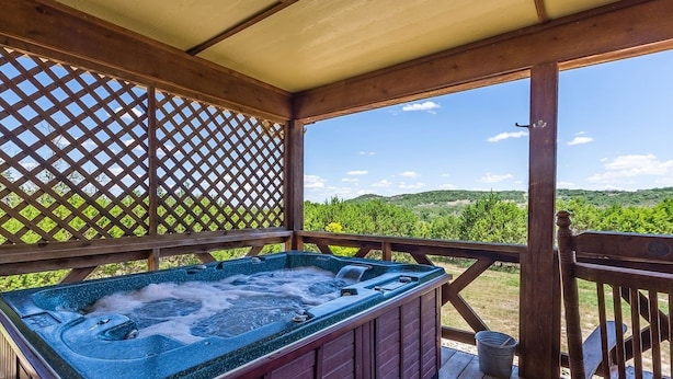 A hot tub in a wooden gazebo with a view of a vineyard. - Appian Way - Oliva Studio Bedroom Cottage by RedAwning (Fredericksburg)