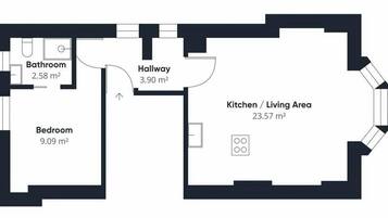 Pianta dell'appartamento con camera da letto (9,09 m²), bagno (2,58 m²), disimpegno (3,90 m²) e angolo cucina/soggiorno (23,57 m²).