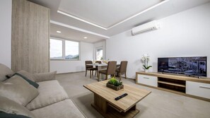 Apartment (One Bedroom Apartment with Jacuzzi an) | Living room | 25-inch flat-screen TV with satellite channels, TV