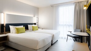 A hotel room with two beds, a desk, and a chair. - Courtyard by Marriott Paris Creteil (Creteil)