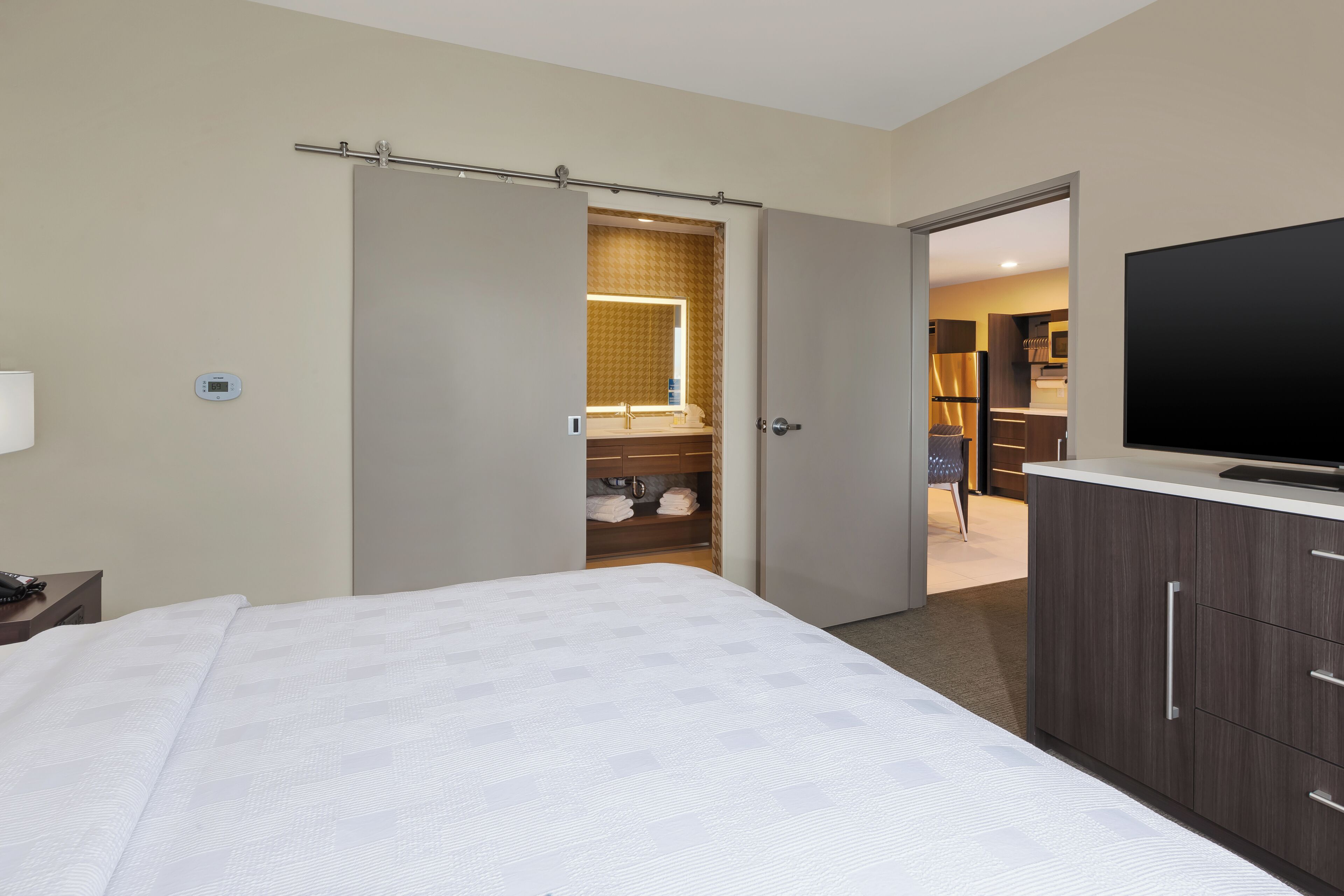 Premium bedding, desk, laptop workspace, blackout drapes