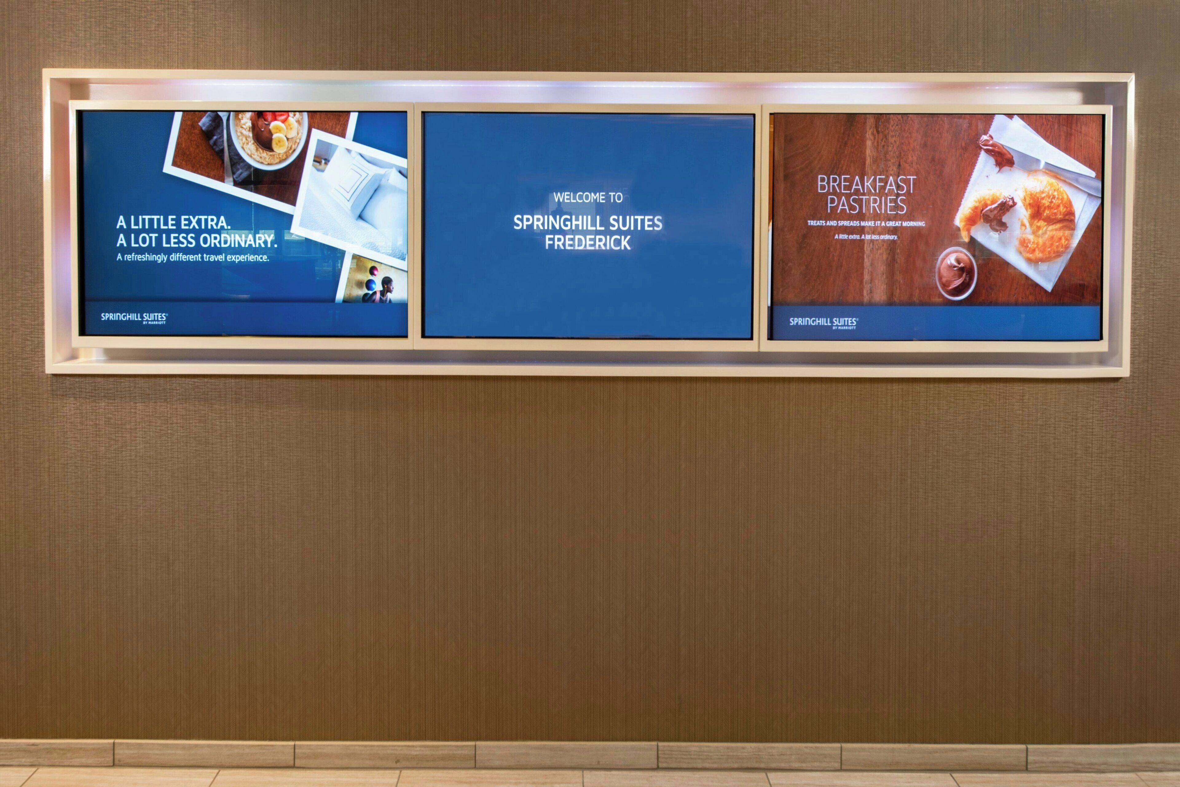 A framed advertisement for Springhill Suites Frederick featuring a breakfast pastries section.