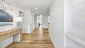 A hallway with white walls, wooden flooring, and recessed lighting. - Cat Daddy 11 bedroom in North Litchfield, Pawleys Island (Pawleys Island)