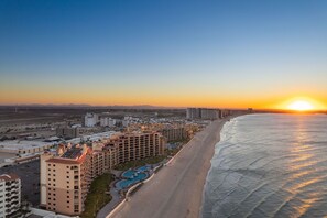 Enjoy stunning ocean views from your balcony overlooking the expansive beach and pool.