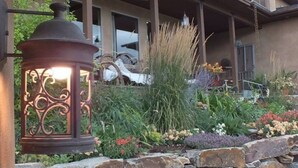 A well-maintained garden with a variety of plants and a decorative metal lantern. - Montana Mountaintop Ranch Estate (Proctor)