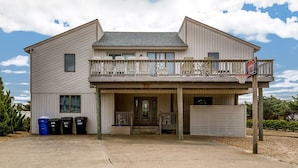 A two-story house with a balcony, a front door, and a garage. - Oceanview, Private Pool, Sleeps 16, Dogs okay, close to beach, PICKLEBALL COURT! (Virginia Beach)
