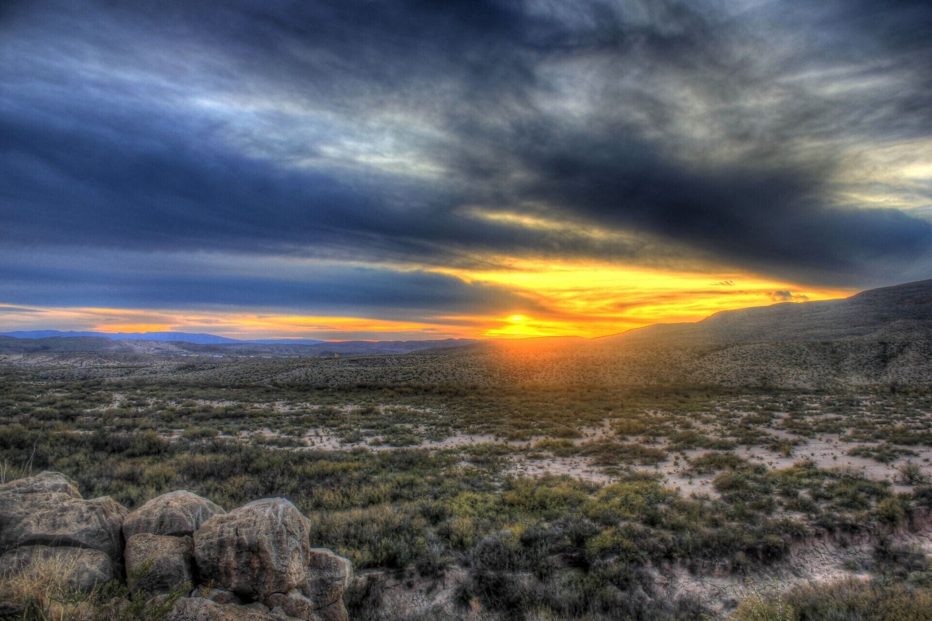 A desert landscape with a sunset.