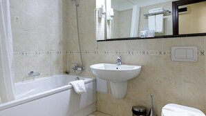 A bathroom with a bathtub, a sink, a toilet, and a shower. - Atrium Hotel Ateneu City Center (Bucharest)
