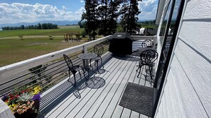 Enjoy al fresco dining and relaxation on this outdoor deck, featuring comfortable seating and a barbecue grill.