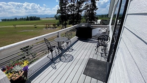 Enjoy al fresco dining and relaxation on this outdoor deck, featuring comfortable seating and a barbecue grill.