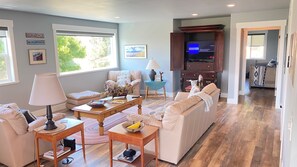 Relax in a cozy seating area with a sofa, armchairs, and a coffee table.