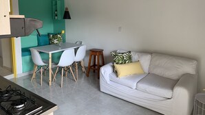 A compact living space with a kitchenette, a dining area, and a seating area.