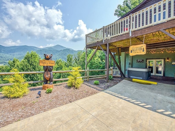 A wooden deck with a sign reading "Valley View" and a bear statue.