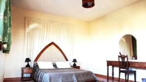 A bedroom with a bed, bedside tables, a desk, and a chair. - Superb Villa in Sonaba Founty Agadir 4998 (Agadir)