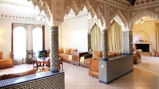 A spacious living area with a high ceiling, intricate tile work, and a fireplace. - Superb Villa in Sonaba Founty Agadir 4998 (Agadir)
