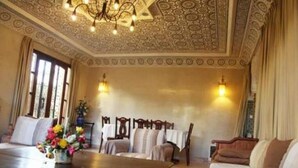 A room with a wooden table, a sofa, and a patterned ceiling. - Superb Villa in Sonaba Founty Agadir 4998 (Agadir)