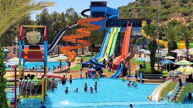A water park with multiple slides and a pool area.