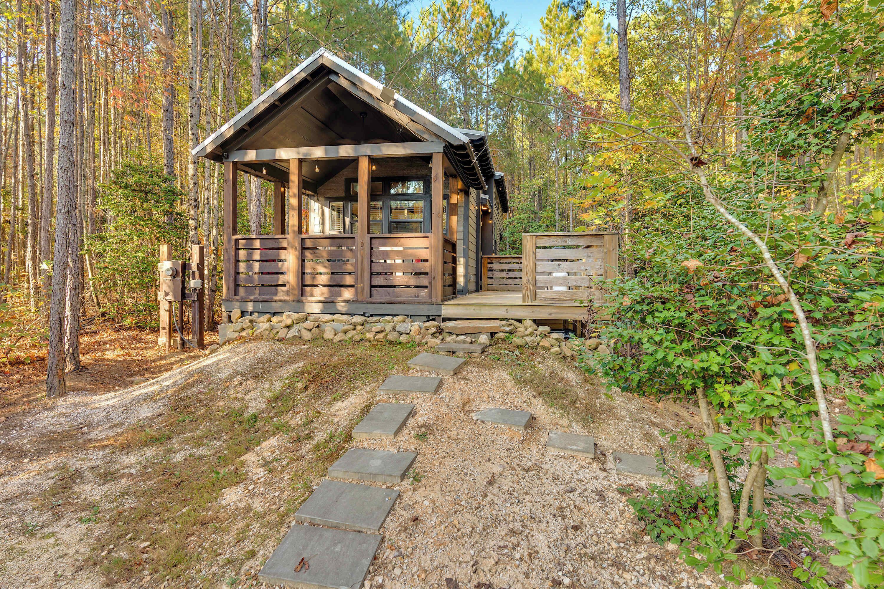 Eine Holzhütte mit Veranda, Steinstufen und einer Holzterrasse.