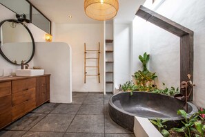 A modern bathroom with a freestanding bathtub, a wooden vanity, a large mirror, and a ladder against the wall. - Tropical Private Villa, 3 BR, Canggu Ricefield View (Canggu)