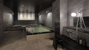 A modern spa room with a large bathtub, a separate shower area, and a vanity with toiletries. - HOTEL SUI KOBE SANNOMIYA by ABEST (Kobe)