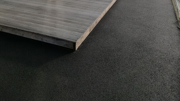 A residential property with a flat roof, a paved driveway, and a wooden deck. - FREHEL HOUSE (Fréhel)