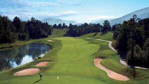 A golf course with a pond, sand bunkers, and a flagstick. - Mountain home close to resort, trails, breweries, & more! (Wintergreen Resort)