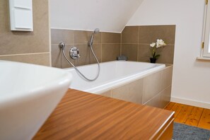 Bathtub, hair dryer, towels, soap