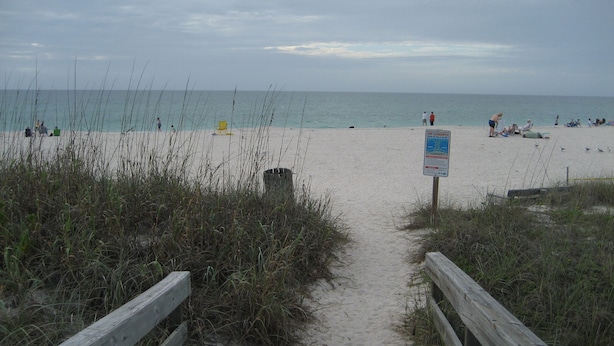 A sandy beach path leading to the sea with a signpost and wooden railings. - A Tropical 2 Bedroom/2 Bath House w/ Pool and Dock (Osprey)
