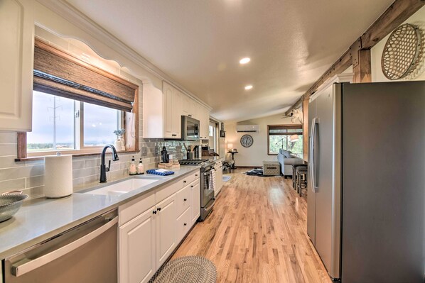 Enjoy cooking in this well-lit kitchen with a large island, sink, and ample counter space.