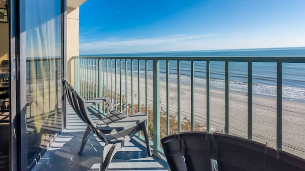 A balcony with a view of the beach, a railing, and two chairs. - Sand Dunes 2626 (Myrtle Beach)