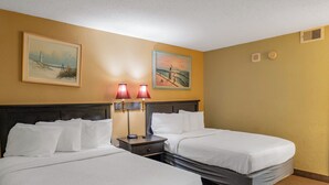 A hotel room with two beds, a nightstand, two wall-mounted lamps, and two framed paintings. - Oceanfront Retreat | Sand Dunes Twenty-Six Twenty-Six (Myrtle Beach)