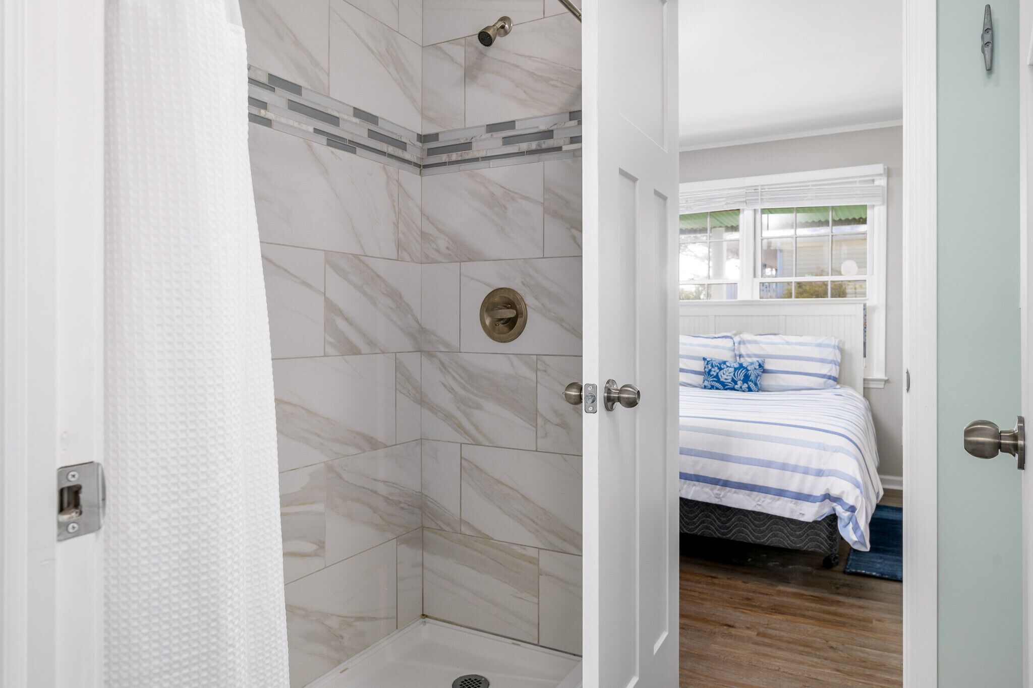 A bathroom with a shower, a toilet, and a sink.