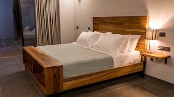 A modern bedroom with a wooden bed, a bedside table with a lamp, and a view of the outside.
