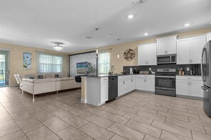 Enjoy a comfortable stay in this apartment with a spacious living area and a well-equipped kitchen featuring a large island with a dishwasher.